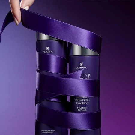 Product shot of two Alterna hair conditioner bottles wrapped in a purple ribbon on a gradient purple background, showcasing product presentation.