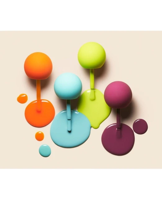Overhead shot of orange, light blue, chartreuse, and magenta nail polish bottles with round handles, with drizzles and a tan backdrop.