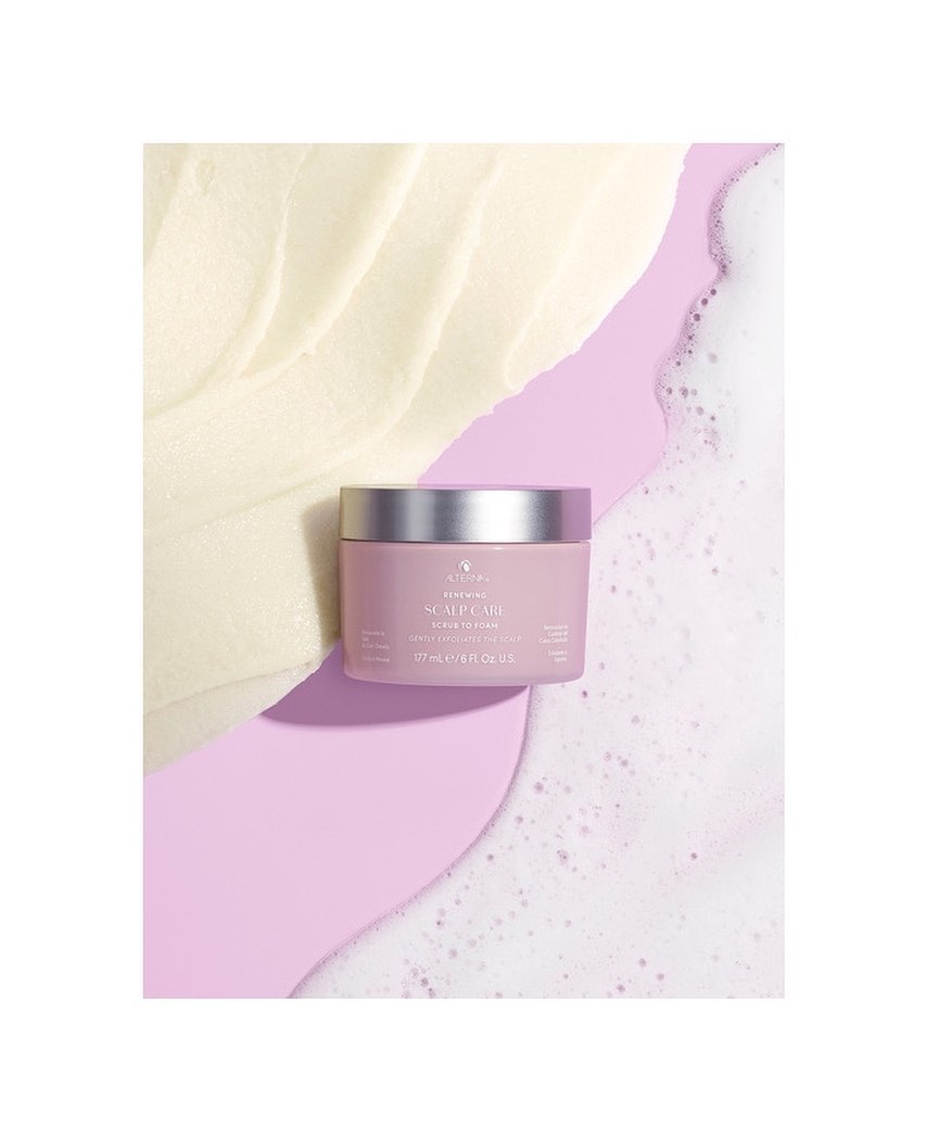 Close-up studio shot of a pink jar of Scalp Lab hair product, surrounded by beige cream, a lavender design and white foam.