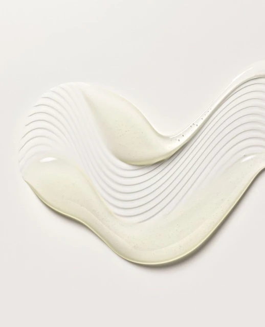 Swirl of pearlescent lotion or cream on white background, ideal for beauty or skincare product demonstration, showing texture.