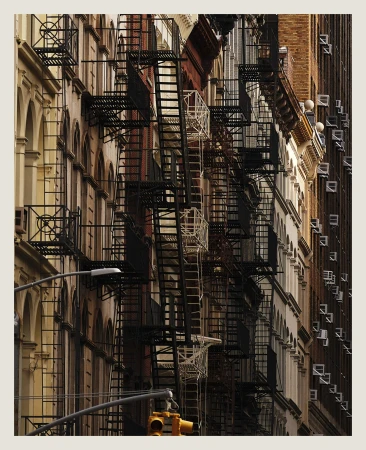 Urban architecture featuring rows of buildings with fire escapes, captured in daytime. The cityscape emphasizes depth and architectural details.