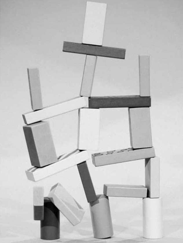 Abstract figure constructed from building blocks, monochromatic image with simple shapes and neutral tones, creating a minimalist aesthetic.