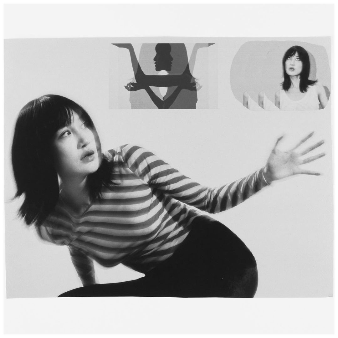 Monochrome photo of an Asian woman in a striped shirt with arm extended, set against a white background with abstract female portraits.