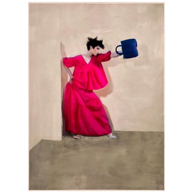 A person poses in a room wearing a pink dress, holding a blue object. The shot captures a fashion-forward art direction with neutral walls.