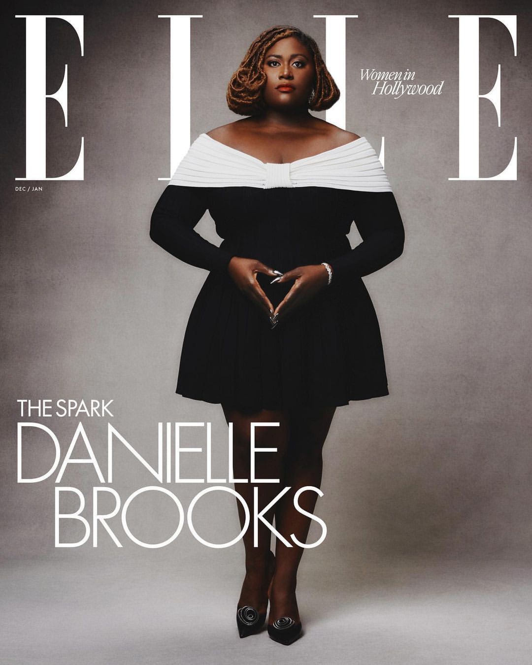 Danielle Brooks on the cover of ELLE Women in Hollywood issue, wearing a black and white dress, making a heart shape with her hands.