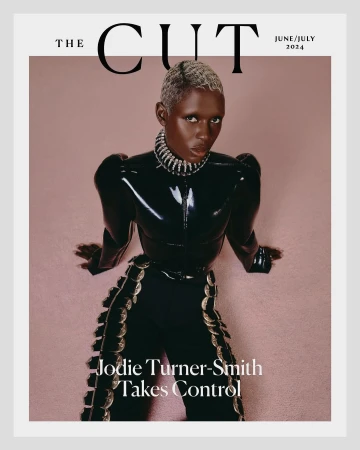 Magazine cover featuring Jodie Turner-Smith in a shiny black outfit and silver jewelry against a light pink backdrop with white trim.