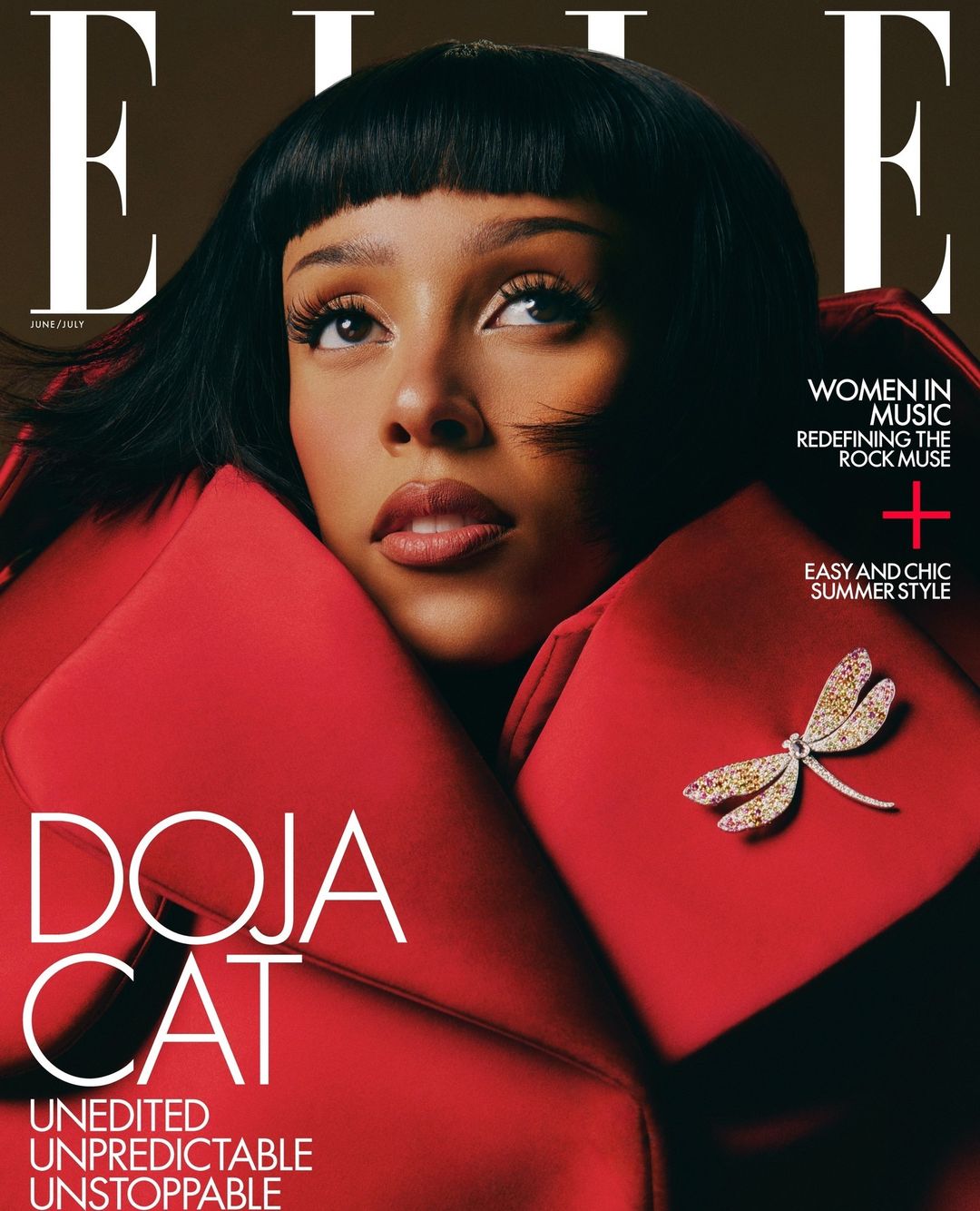 Elle magazine cover featuring Doja Cat in a red jacket, adorned with a dragonfly brooch, against a dark background.