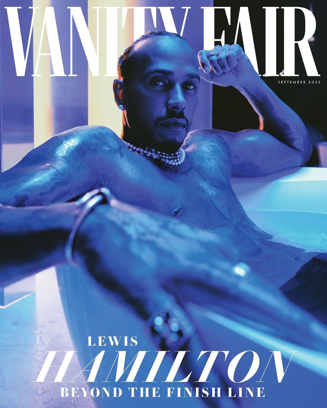 Lewis Hamilton, athlete, is featured on the Vanity Fair magazine cover, September 2022 issue, wearing jewelry in a bathtub of water.