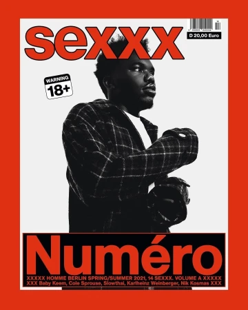 Magazine cover featuring a dark-haired man in a plaid jacket with red and white text and warning labels on a red-bordered background.