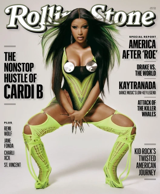Magazine cover featuring Cardi B in a futuristic, neon-green outfit, posing with spread legs and long nails. The Rolling Stone logo is visible.
