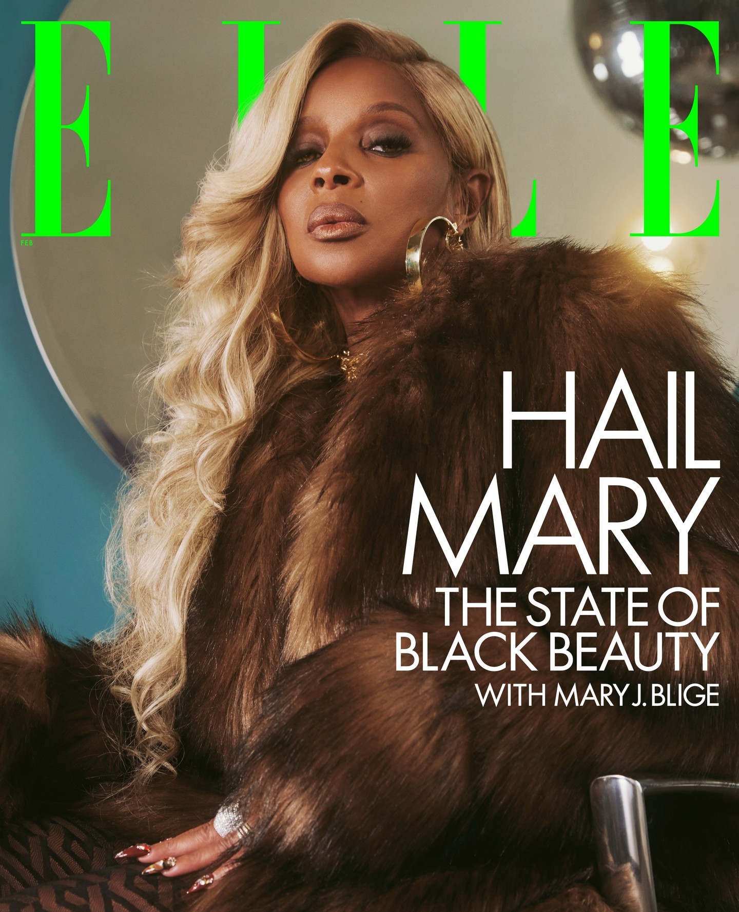 Mary J. Blige on the cover of Elle magazine wearing a brown fur coat, gold jewelry, and blonde wavy hair in a studio setting.
