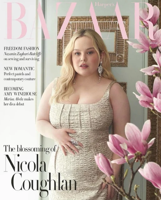 Nicola Coughlan covers Harper's Bazaar, posing in a gold textured dress beside pink magnolia blooms, in a portrait-oriented magazine cover.