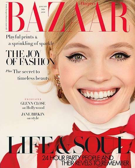 Fashion magazine cover featuring a close-up of a smiling woman with blonde hair, elegant makeup, and a red and white patterned top.