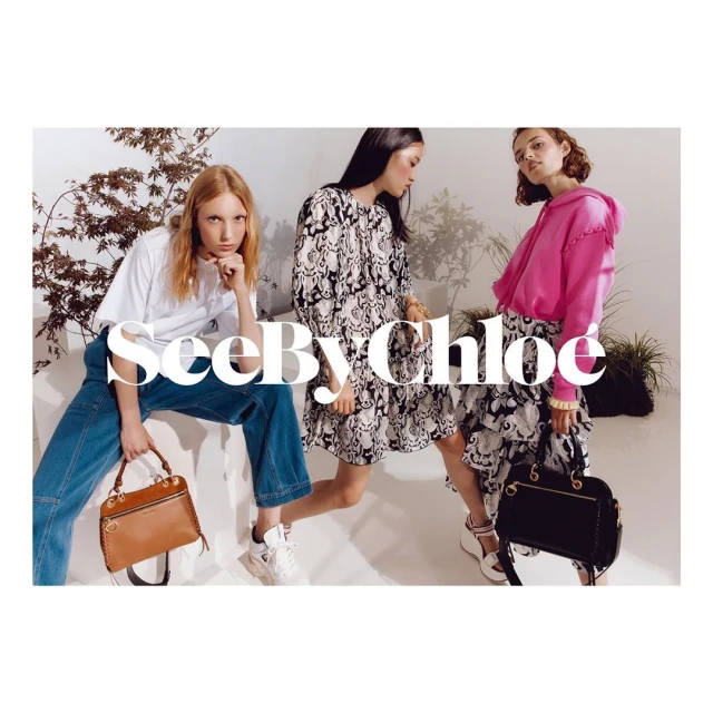 Three fashion models showcase See By Chloé handbags. The women pose indoors, styled in dresses, jeans, and a hoodie, complemented by purses.