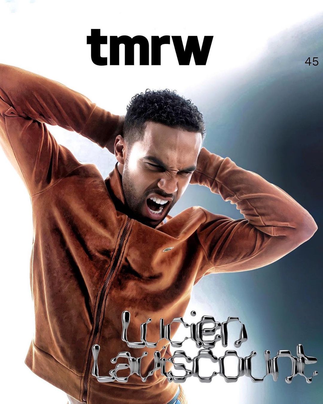 Magazine cover featuring a man with a distressed expression wearing a brown jacket against a blurred background with bold typography.