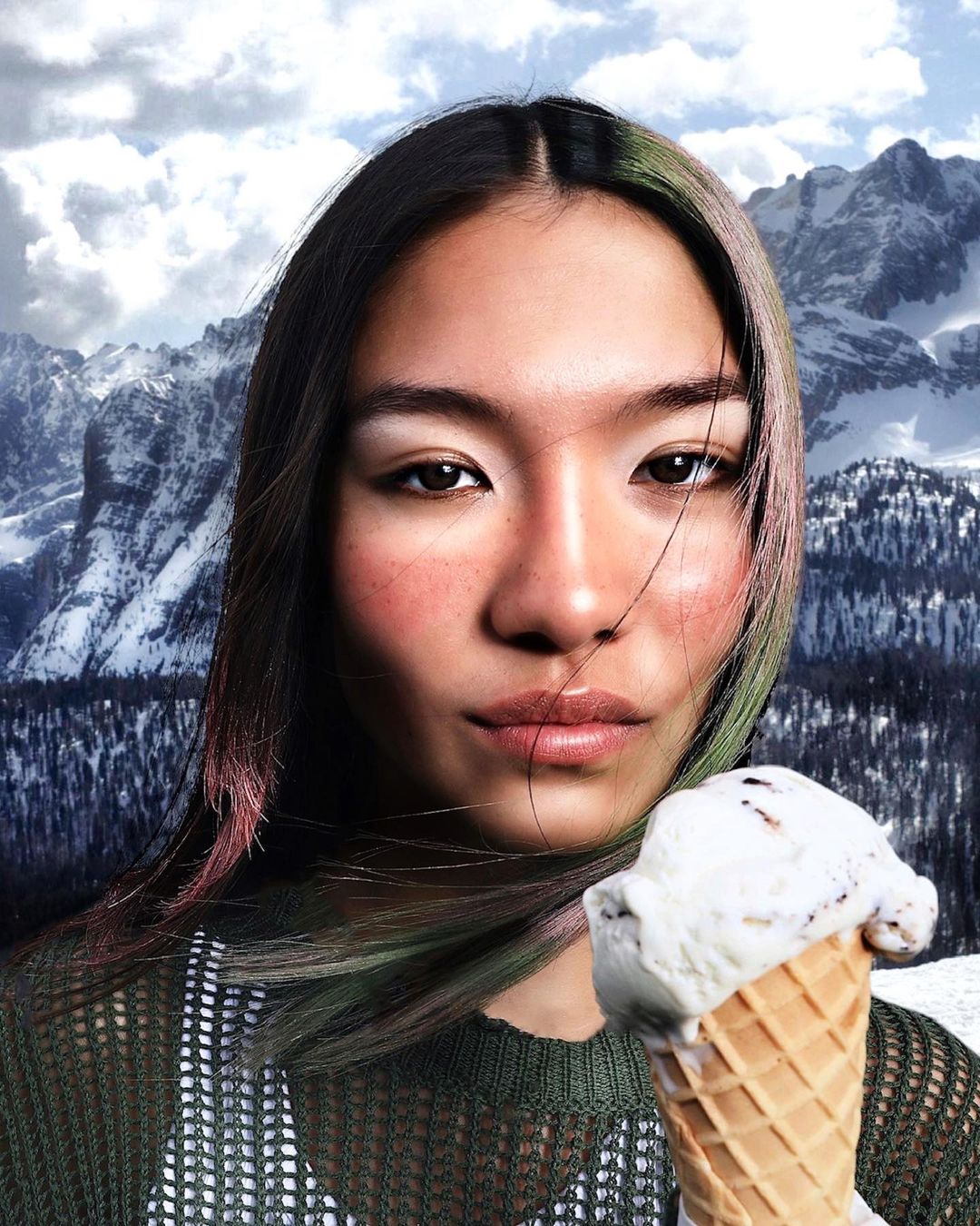 Asian woman eats melting ice cream cone against snowy mountain backdrop. Close-up portrait with food and winter scenery.