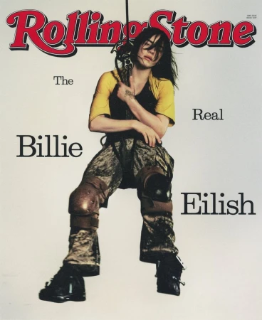 Rolling Stone cover featuring Billie Eilish in knee pads and yellow shirt, holding equipment against a white backdrop with magazine text.