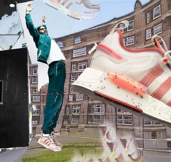 An athletic man in a green tracksuit jumps high with Adidas sneakers, showcasing a dynamic urban fashion scene with blurred city backdrop.