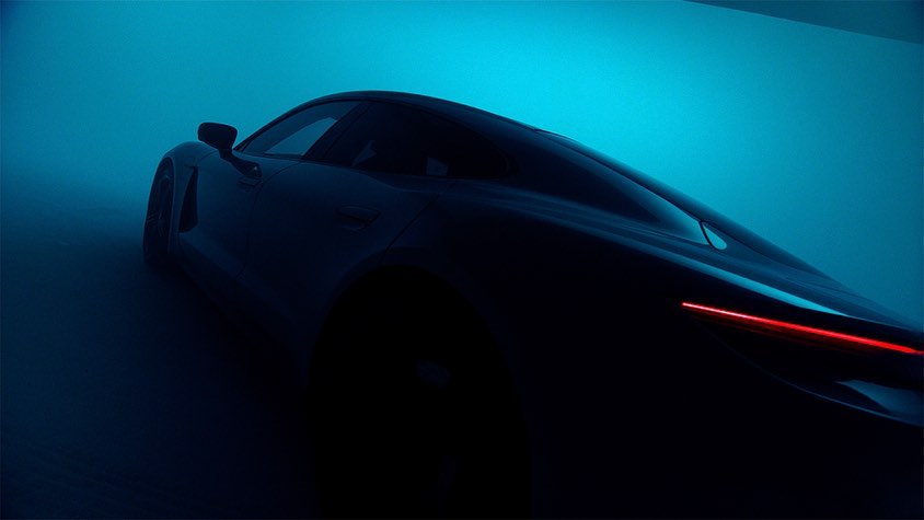 A sleek, dark sports car is showcased against a vibrant blue backdrop, highlighting its aerodynamic lines and modern design elements.