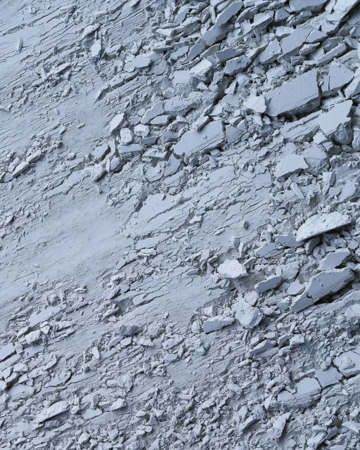 Abstract close-up of fragmented material shows a textured surface with cracks and scattered pieces, offering a monochromatic look.