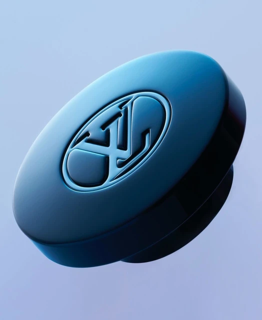 Close-up of a round, blue-toned device or component featuring a debossed logo, set against a soft, gradient blue background.