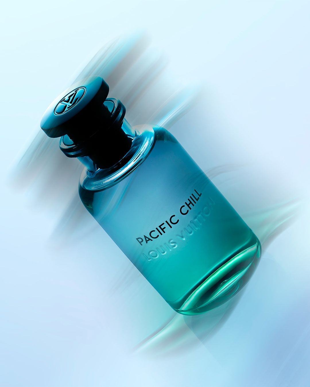 Turquoise-gradient perfume bottle, Pacific Chill by Louis Vuitton, angled view with blurred white background. Beauty, luxury, fragrance product shot.
