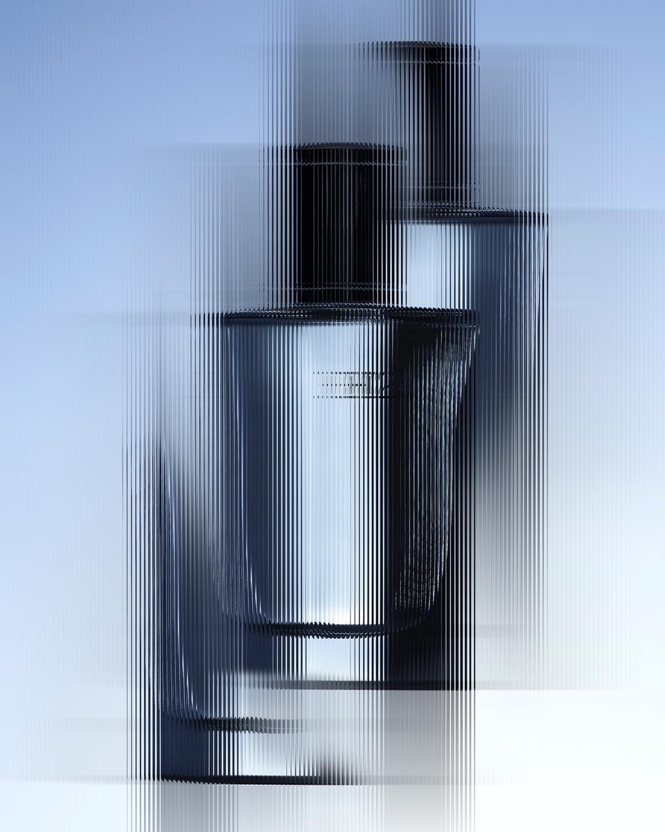Two perfume bottles viewed through a vertically distorted glass filter against a pale blue and white background