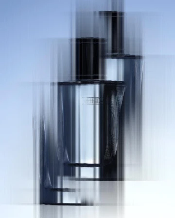 Two perfume bottles viewed through a vertically distorted glass filter against a pale blue and white background