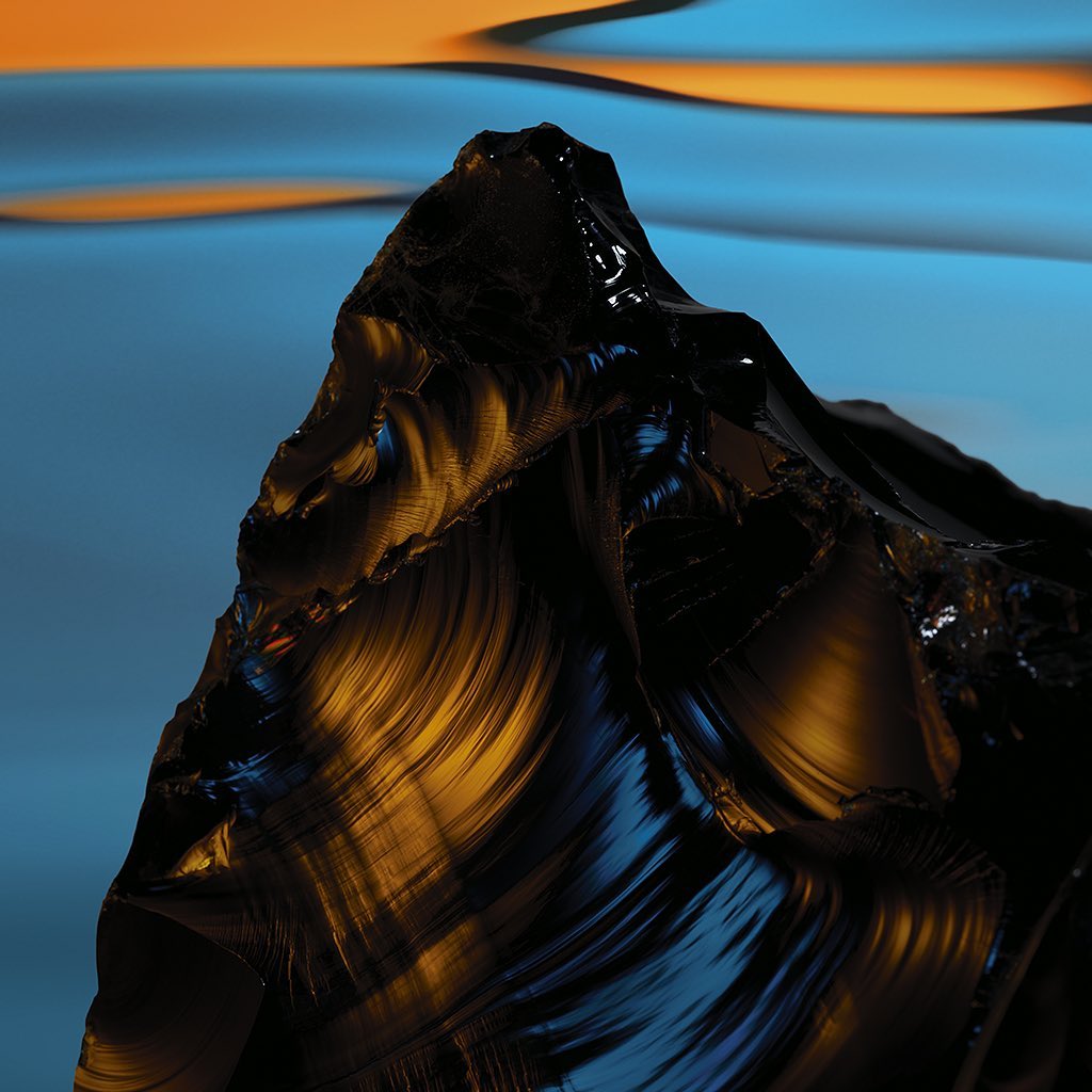 Close-up of a jagged, reflective black obsidian stone with visible ridges and gold highlights against a blue and orange background.