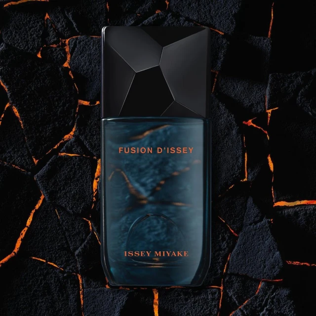 CGI studio shot of Issey Miyake Fusion d'Issey fragrance bottle with volcanic rock background, showcasing modern product design and texture.