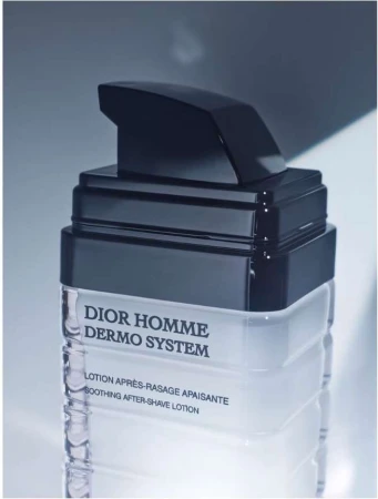 Dior Homme Dermo System after-shave lotion in a clear bottle with black pump. Beauty product with a minimalist design.