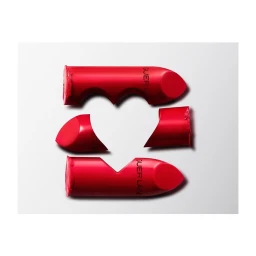 Three pieces of red lipstick arranged on a white background to form a heart shape in the center