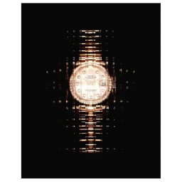Close-up of a gold luxury watch with a diamond bezel against a dark background, photographed by Alain Costa.