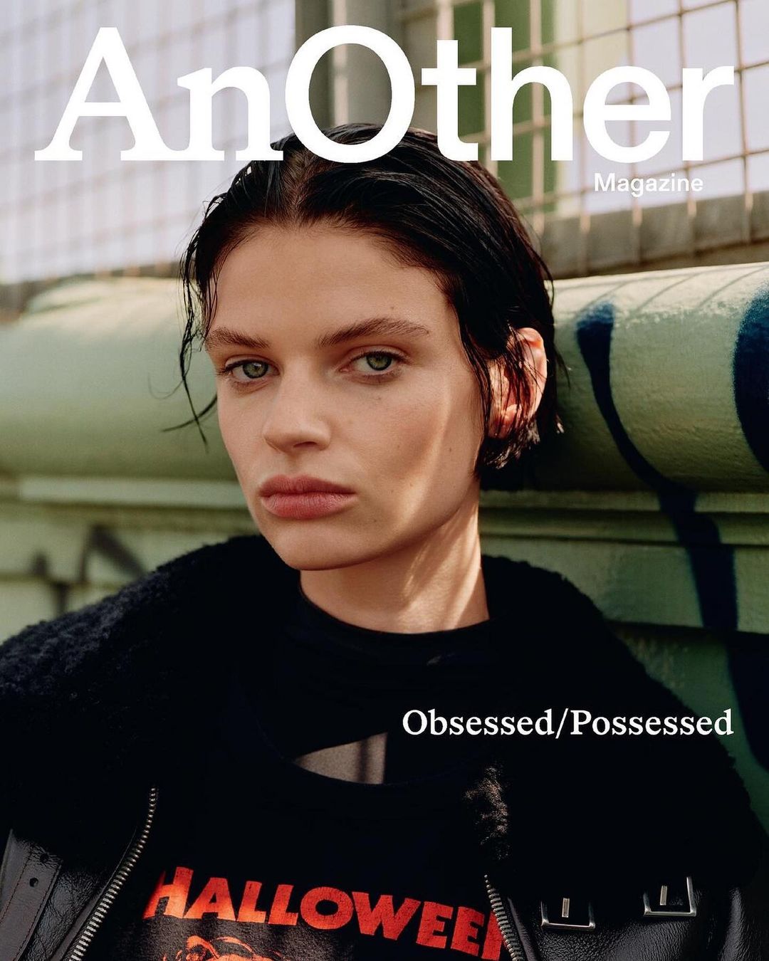 Magazine cover featuring a woman with dark hair wearing a Halloween t-shirt and black jacket, photographed on a rooftop.