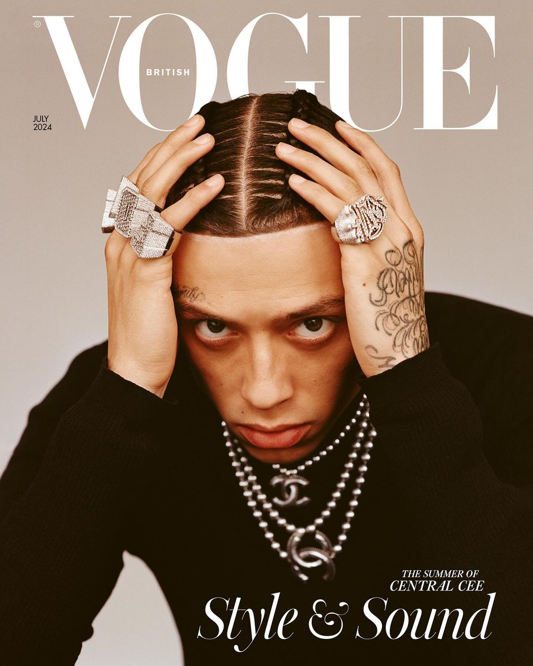 British Vogue cover featuring Central Cee with braids, rings, and layered necklaces in a close-up shot against a neutral background.