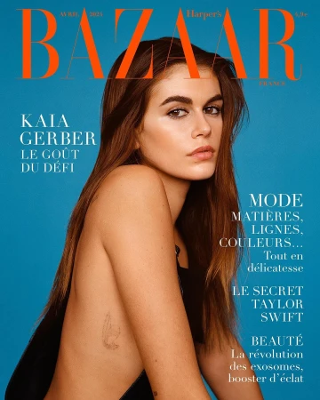 Harper's Bazaar cover featuring Kaia Gerber against a blue background. Editorial fashion photography showcasing minimalist style.