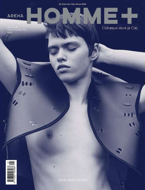 Magazine cover of Arena Homme+ featuring a young adult male model with eyes closed wearing a decorative leather vest and graphic design.