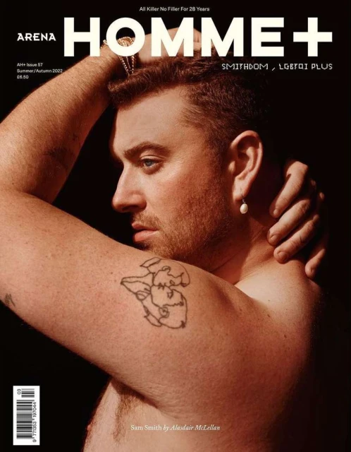 Close-up magazine cover featuring Sam Smith, captured in warm studio lighting, showcasing tattoo detail and pearl earring, with bold magazine typography.