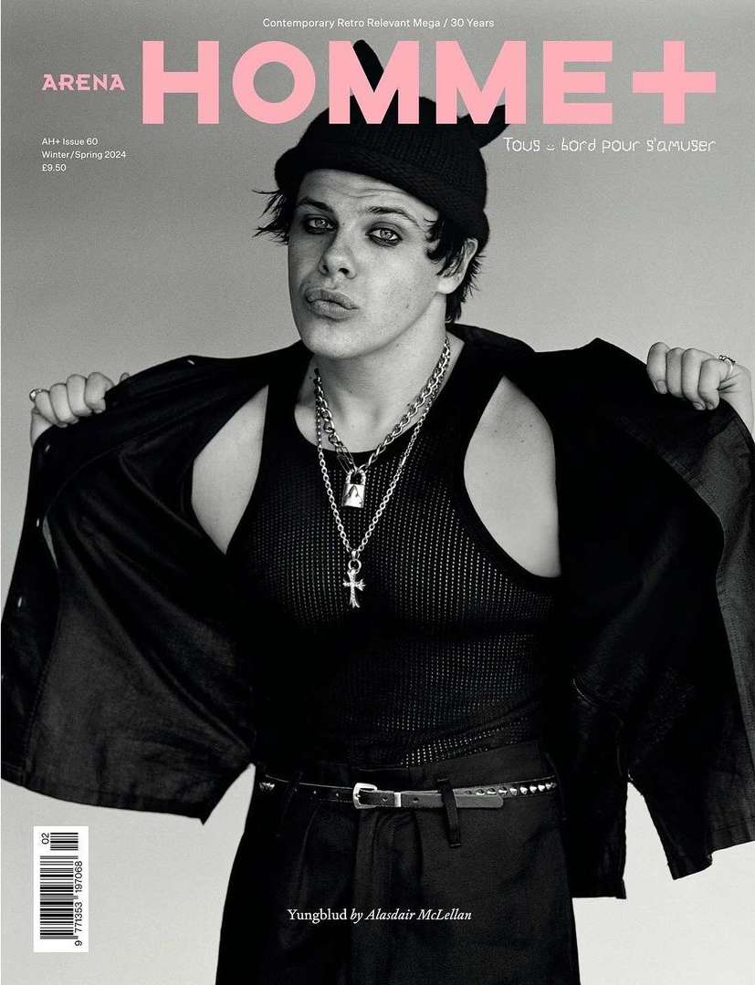Black and white magazine cover shot of Yungblud in a tank top, chains, black pants, and beanie, photographed by Alasdair McLellan.