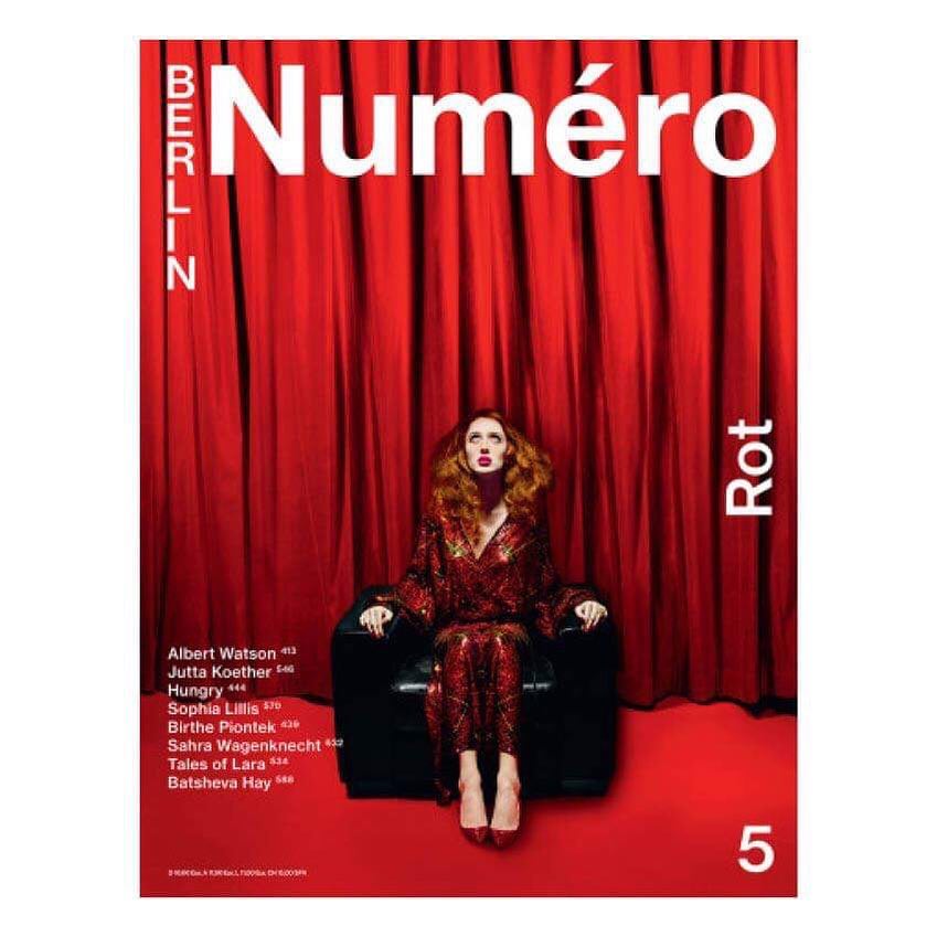 Magazine cover featuring a woman in a red outfit sitting in a chair against a red curtain, promoting Numero Berlin and the color red.