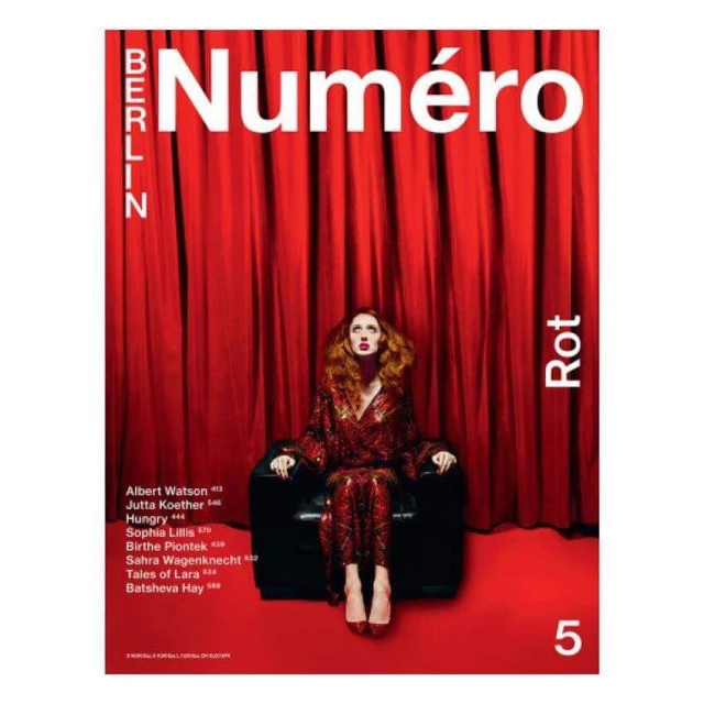 Magazine cover featuring a woman in a red outfit sitting in a chair against a red curtain, promoting Numero Berlin and the color red.