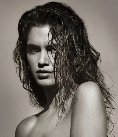 Close-up monochrome portrait of a woman with wet tousled hair and serious expression photographed by Albert Watson