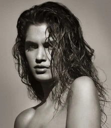 Close-up monochrome portrait of a woman with wet tousled hair and serious expression photographed by Albert Watson