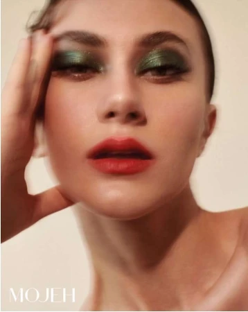 Close up portrait of a woman with metallic green eyeshadow and red lips by photographer Alena Sazonova
