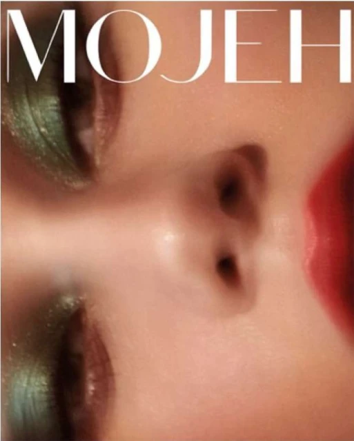 Close-up studio shot of a face with green eyeshadow and red lipstick. The text 'MOJEH' is visible in the upper portion of the frame.