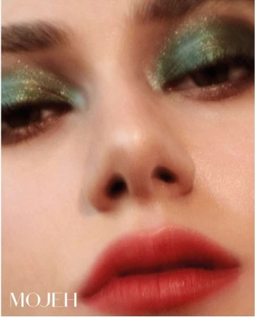 Extreme close-up portrait of a woman wearing shimmering green eyeshadow and bright red lipstick, photographed by Alena Sazonova