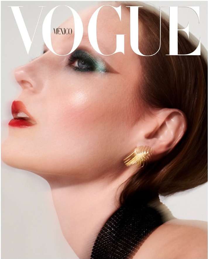 Vogue Mexico cover featuring a model with dramatic emerald eye makeup and bold red lips, adorned with a golden, sculptural earring.
