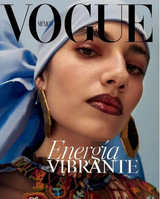 Vogue México cover featuring a close-up of a woman with light skin, wearing a blue headscarf, gold earrings, and a colorful patterned top.