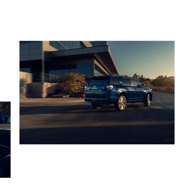 Blue SUV driving on a paved road with a modern building in the background, showcasing automotive design and outdoor driving.