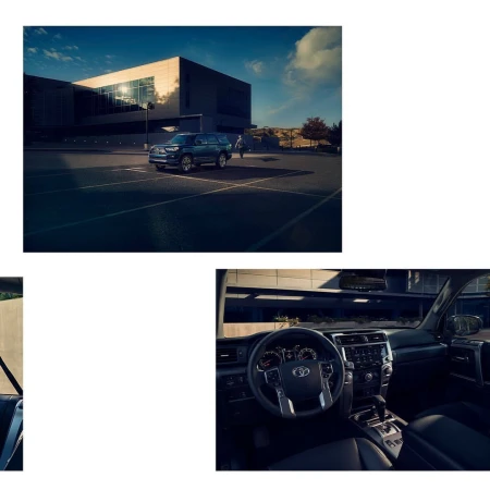 Blue SUV parked in an empty asphalt parking lot outside a modern glass and steel building under a clear blue sky
